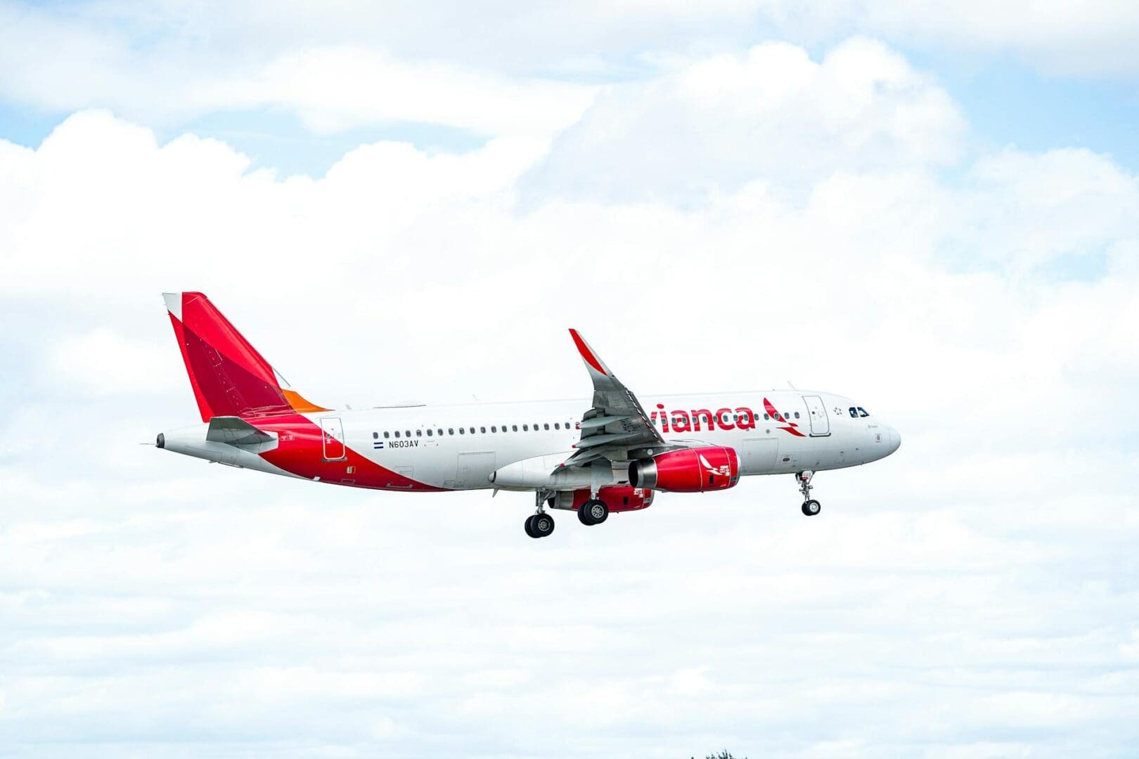 A red and white Lanka Airlines plane flying in the sky.